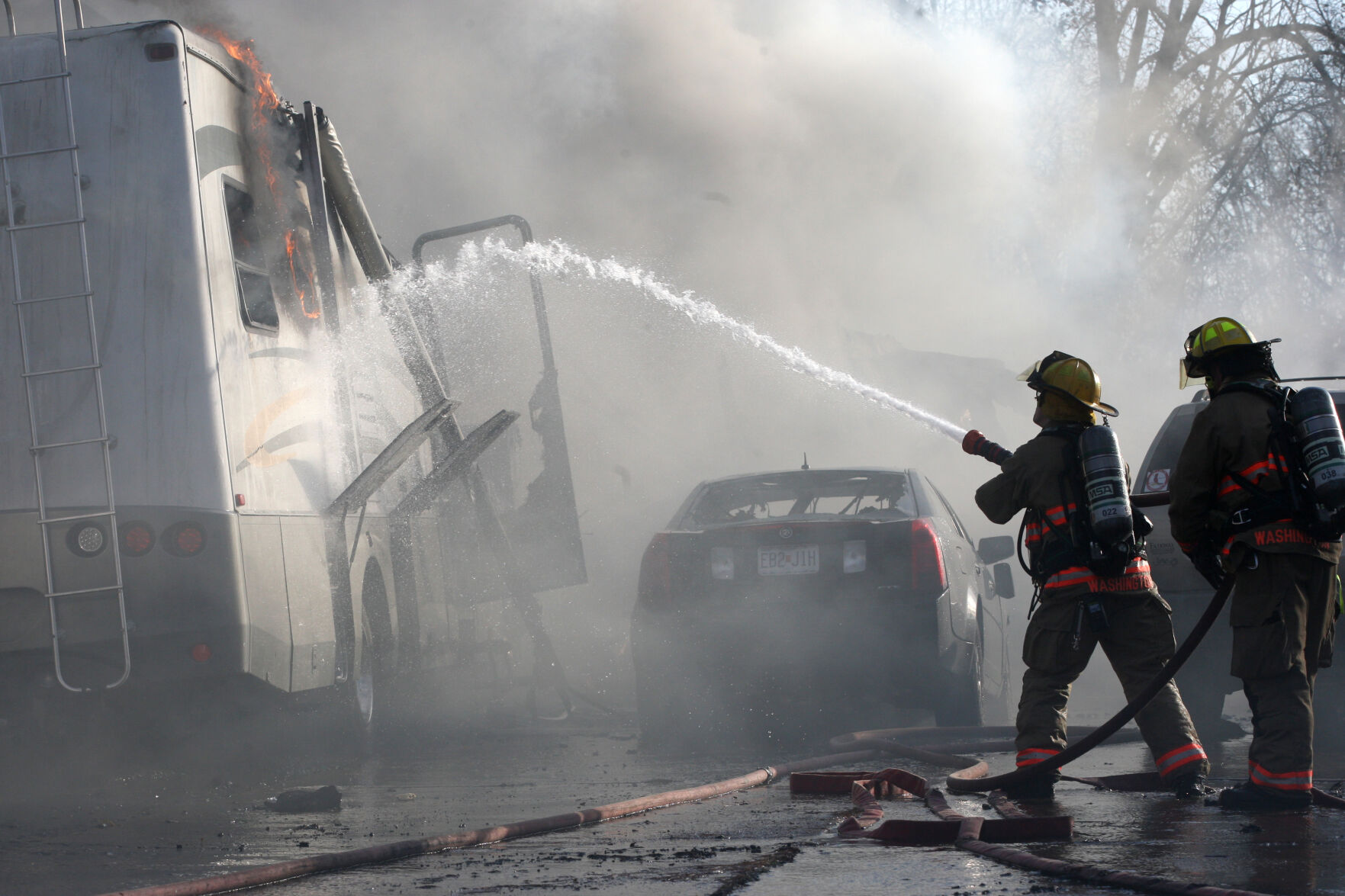 Firefighters attack RV fire